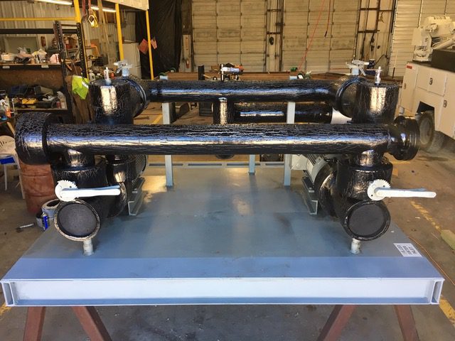 Two used Bell & Gossett 15HP Pumps skid mounted with Suction Diffusers, Isolation Valves, and Supply and Return Headers