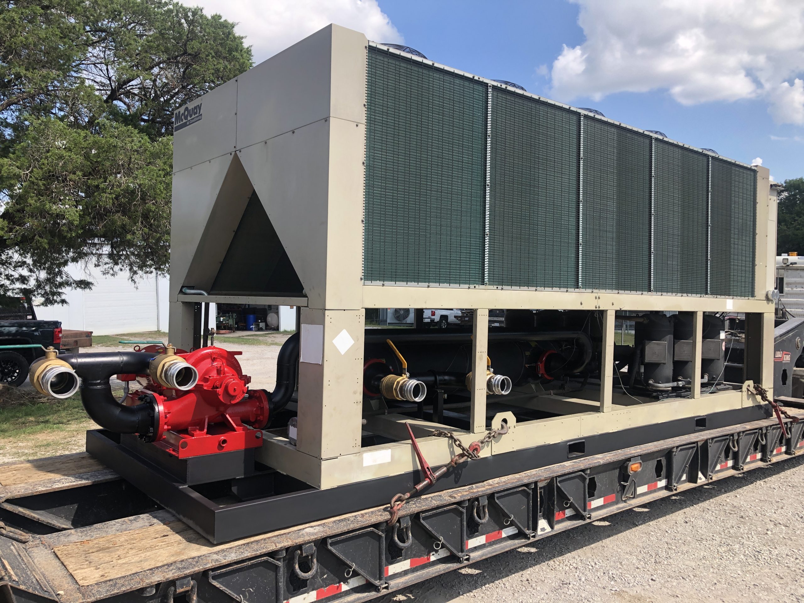 Used 180 Ton McQuay Air Cooled Chiller mounted on a custom forkable skid with a Used 15HP Weinman Pump